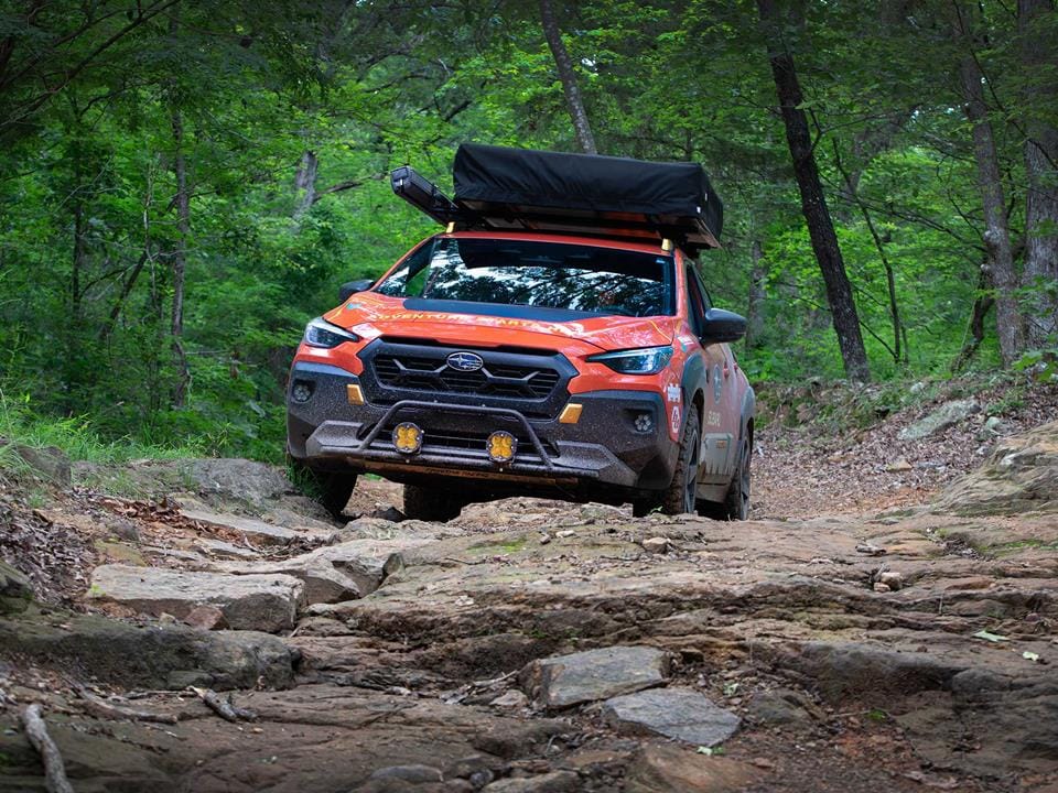 Warloop Road, western Arkansas — narrow, downhill, overgrown, with rock ledges and off-camber sections.