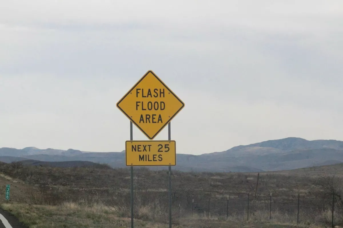 Flash flood warning sign in Cochise County, Arizona, marking a known wash crossing.
