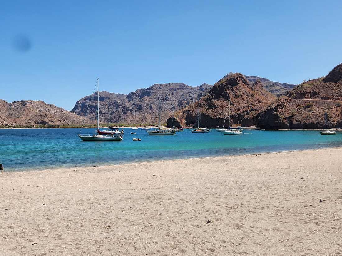 Small fishing boats anchored in Aqua Verde bay.