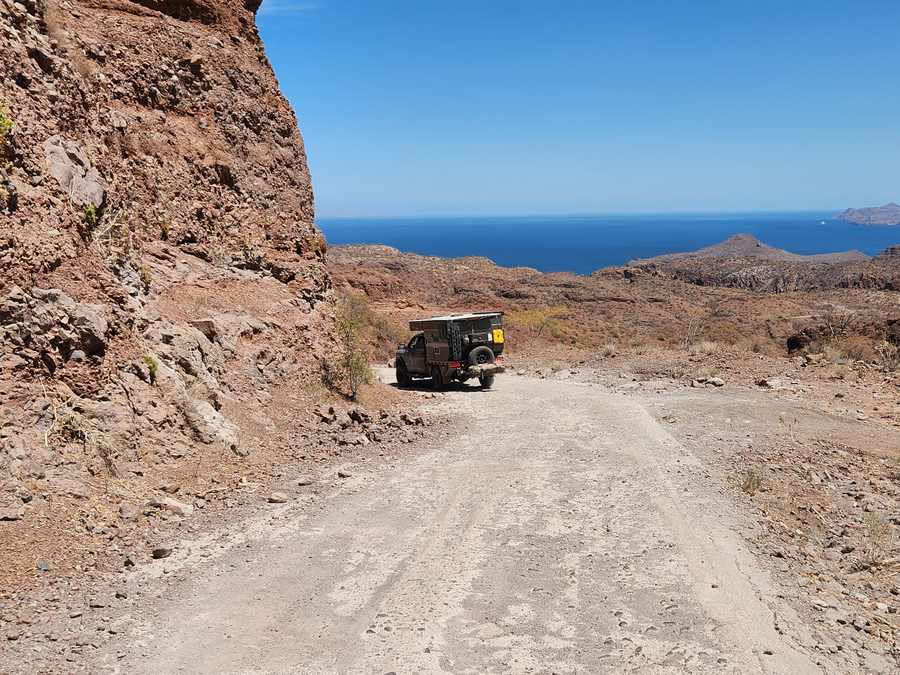 The steep, unpaved road descending toward Aqua Verde on Baja California Sur.