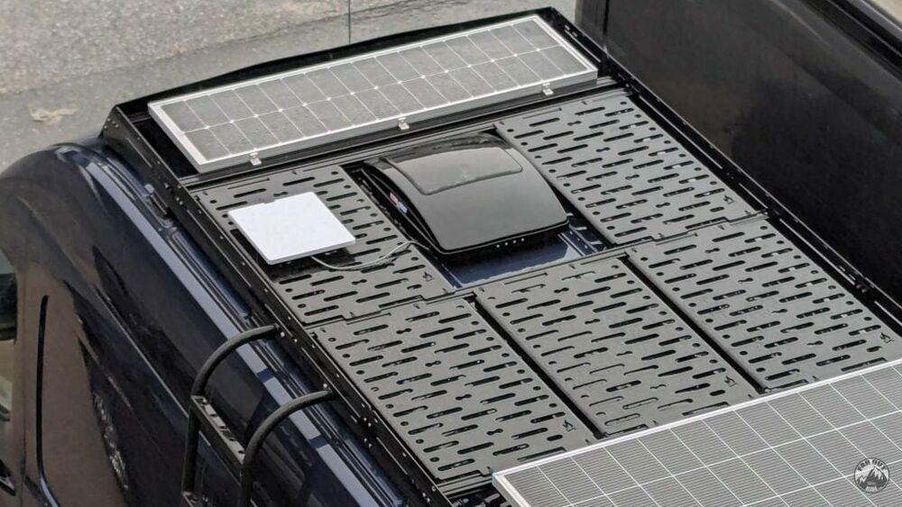 The Mini mounted on a van roof next to solar panels - work-from-anywhere install.