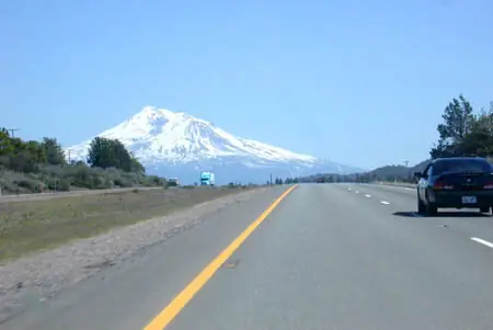 Mount Shasta seen from Interstate 5 near the town of Mount Shasta, California — the view every northbound driver gets before the climb.