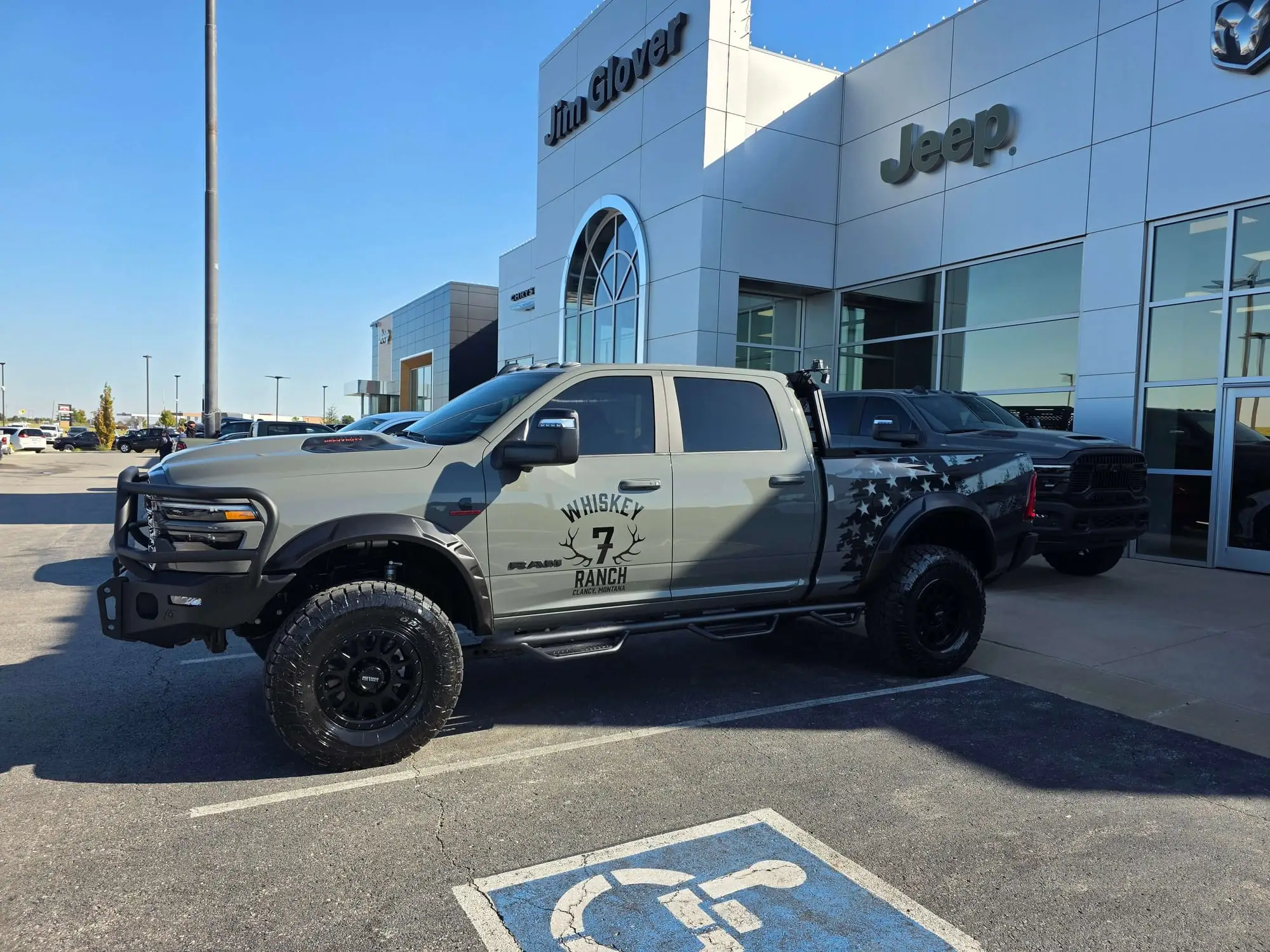 Modified Ram pickup truck outside a Jim Glover Jeep dealership