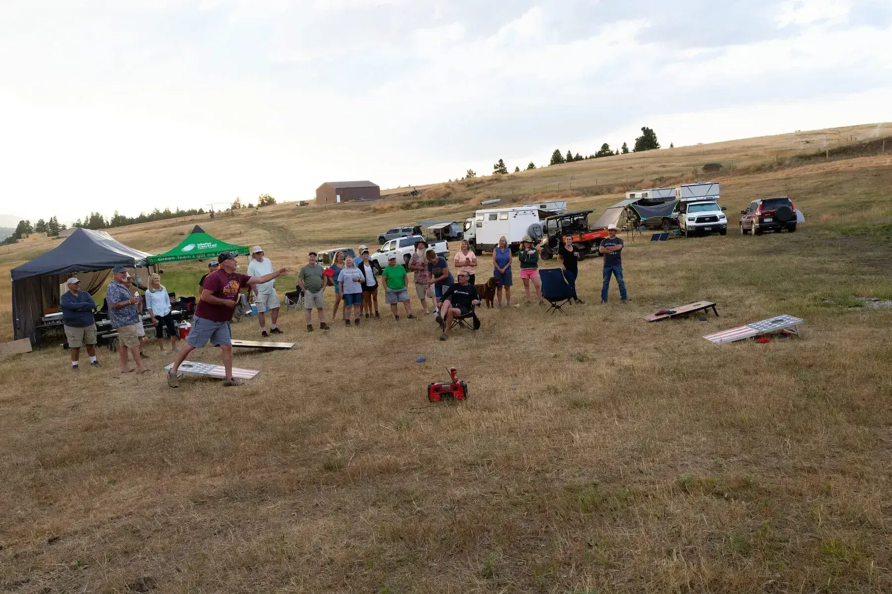 People playing cornhole at a campsite
