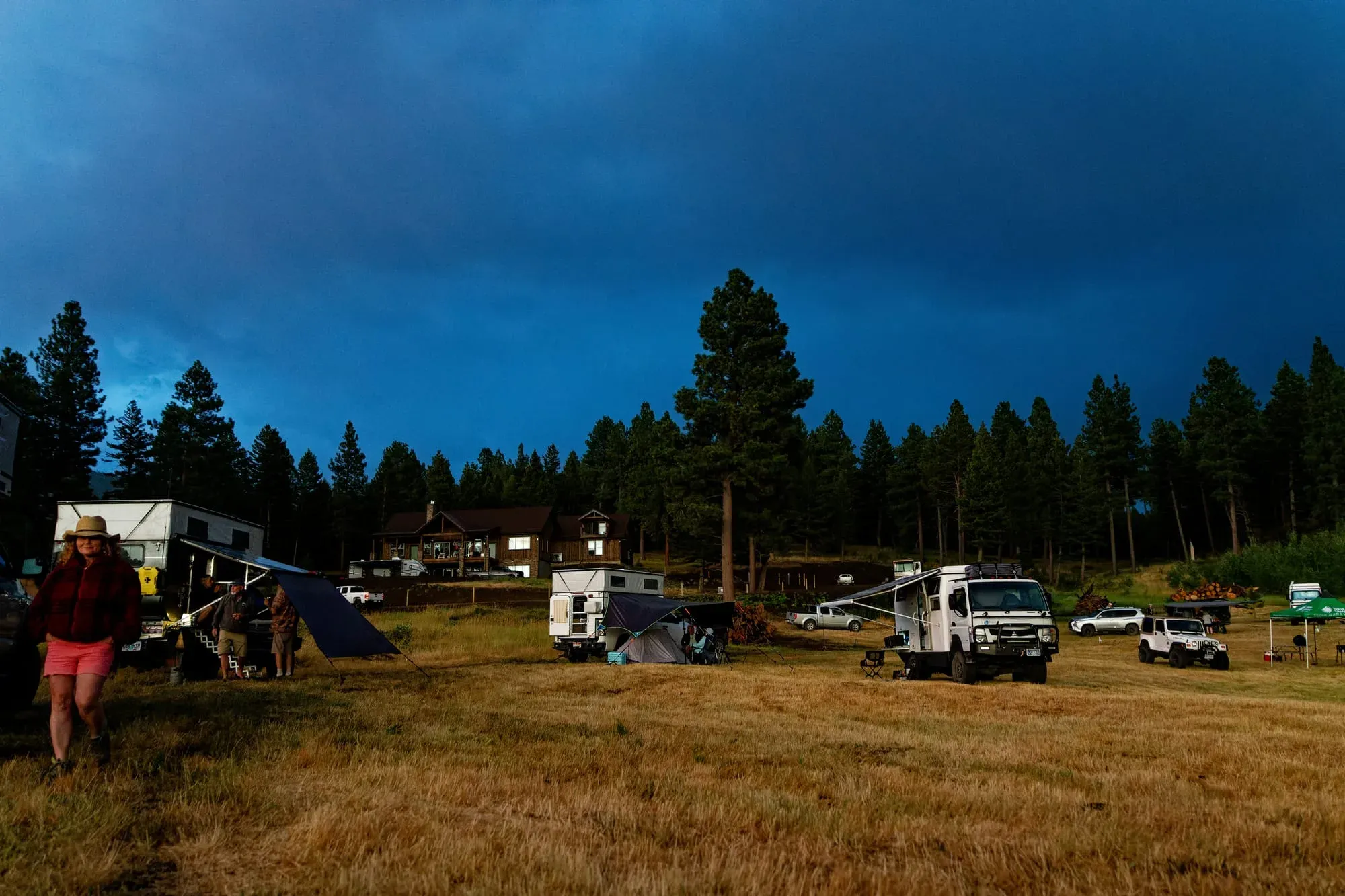 Campground with tents, RVs, and cabins