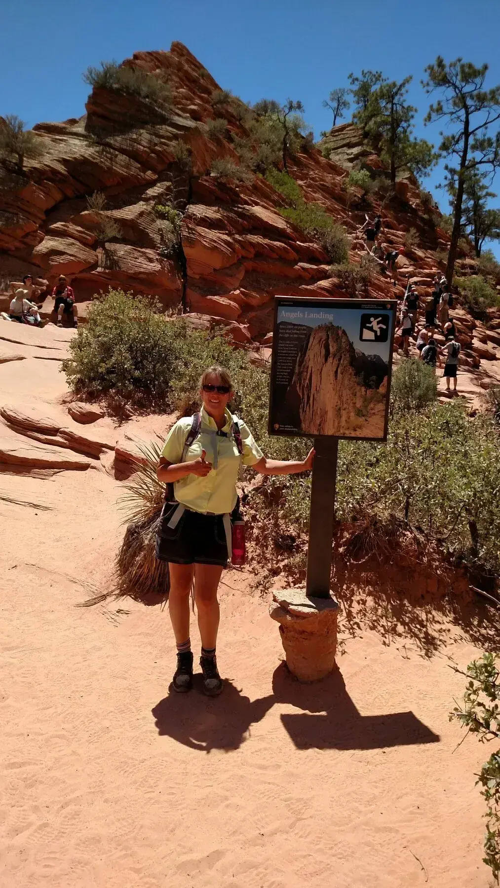 Hiker beside an Angels Landing trail sign