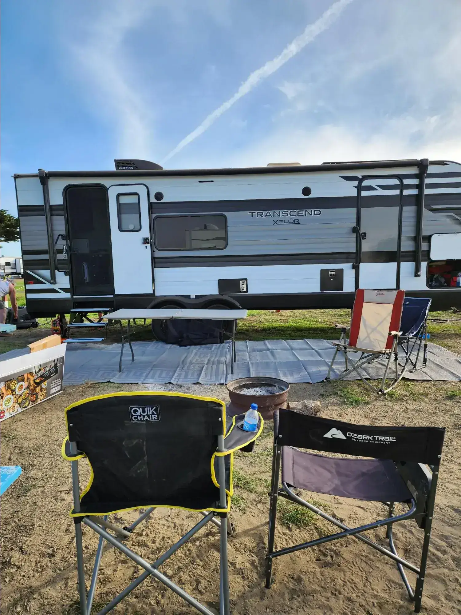 Gray travel trailer at a campsite
