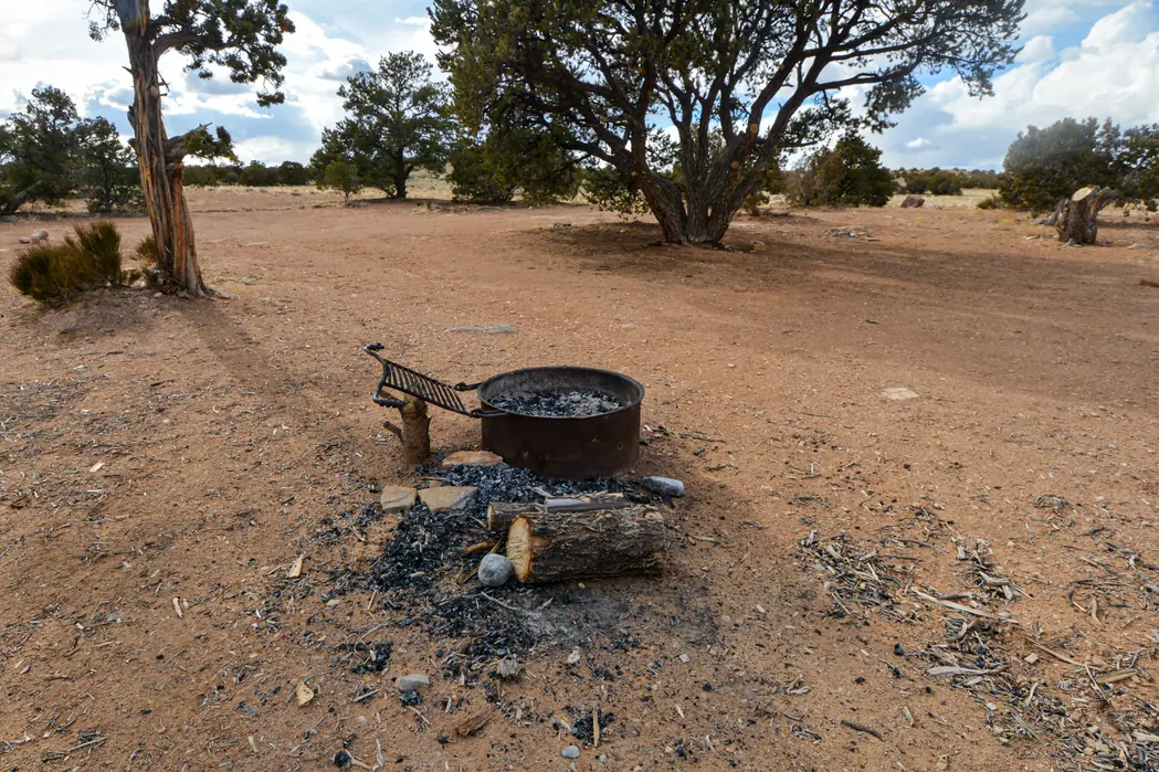 A campfire and campsite on BLM land in Utah, captioned as a reminder to Leave No Trace and recreate responsibly