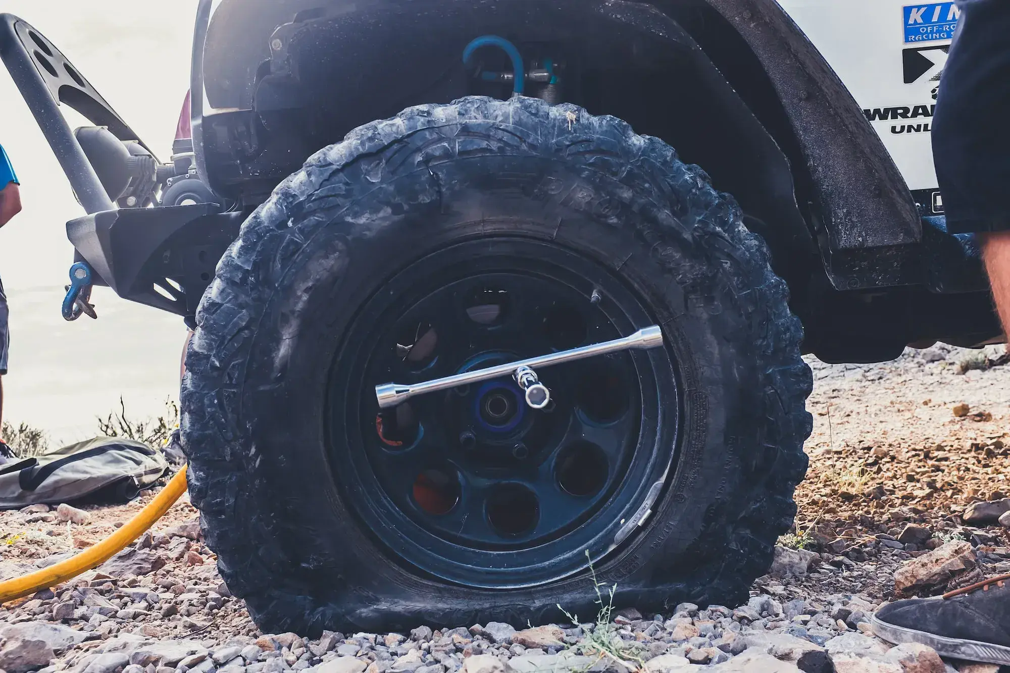 Close-up of an off-road vehicle tire on rocky ground
