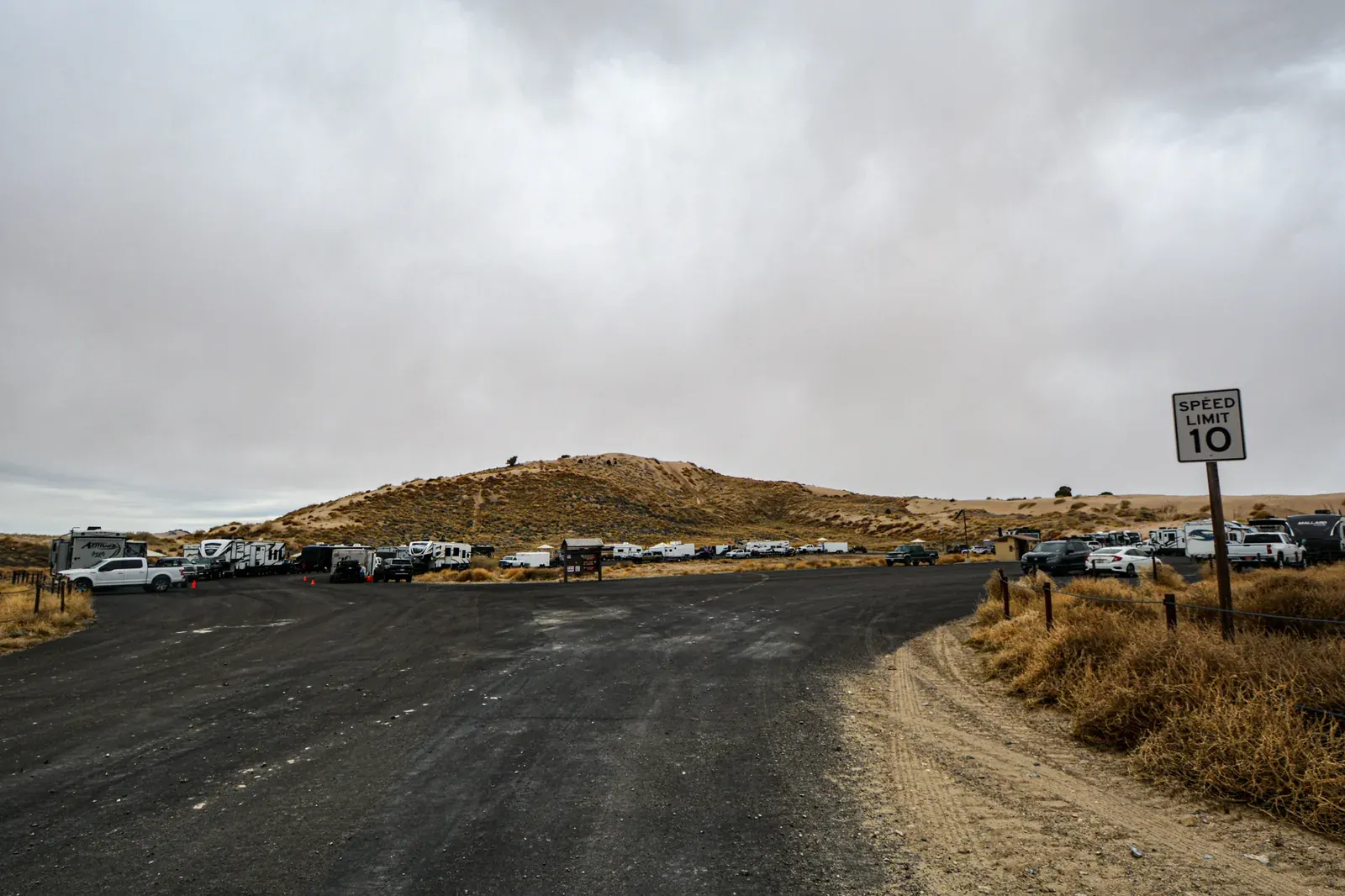 An RV and trailer camping at Little Sahara Recreation Area on BLM land in Utah