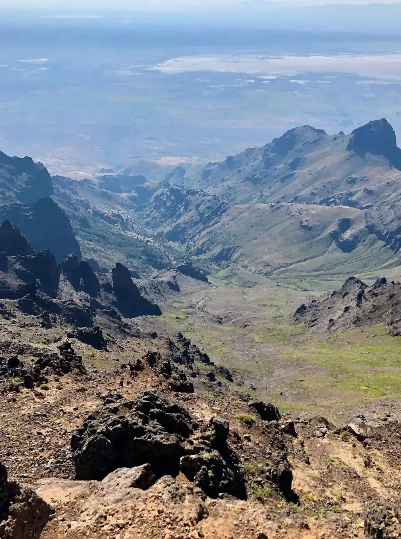 Jagged volcanic peaks above a broad rocky valley