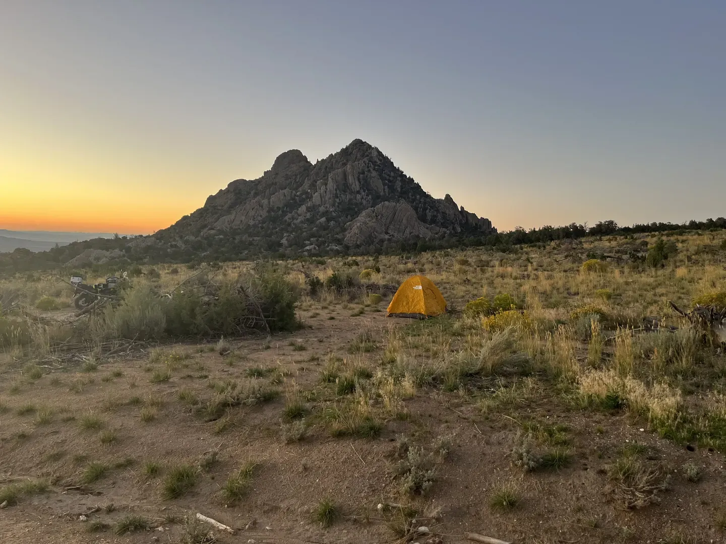 A tent at sunrise near designated routes at Devil's Playground on BLM land in Utah