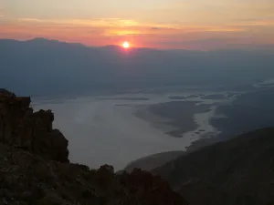 Death Valley salt flats seen from Dante's View at sunset beneath silhouetted mountains