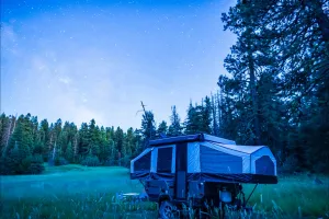 A pop-up truck camper on a pickup parked in a mountain clearing under the Milky Way, Cascade-Siskiyou National Monument.